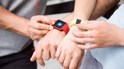 Two people wearing smart watches