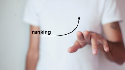 Person clicking on screen with ranking SEO arrow pointing up