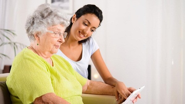 photo of young woman with grandma pointing to ipad